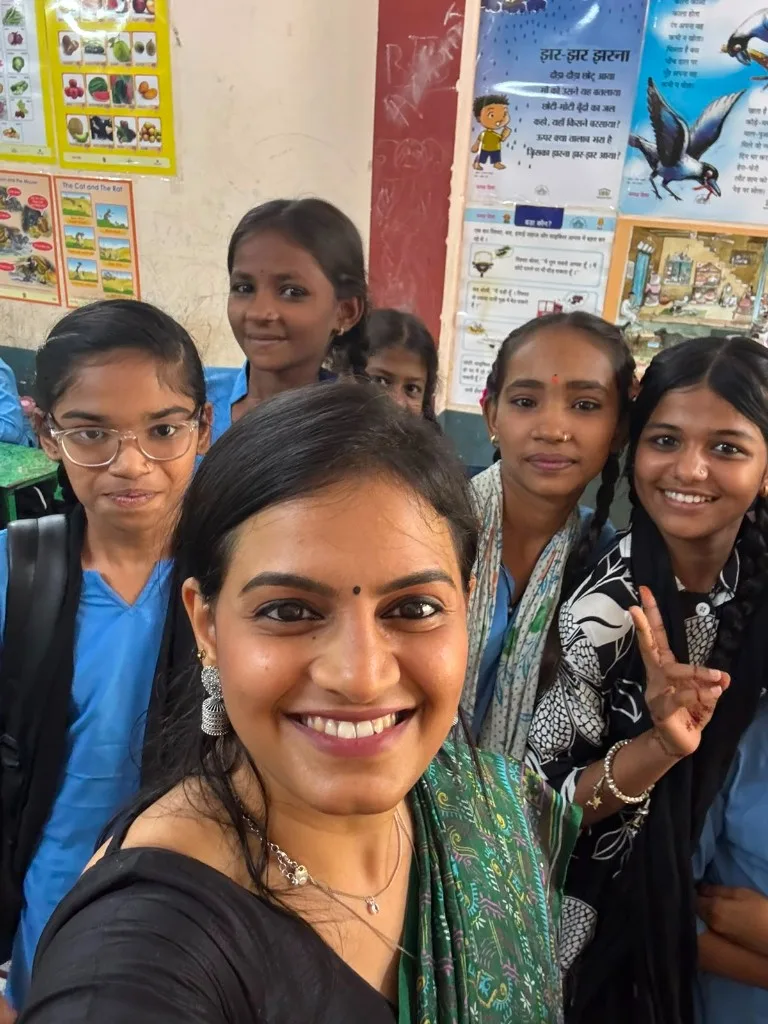SAANJ team member with schoolgirls in a classroom